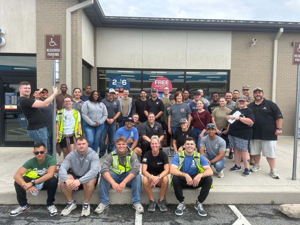 A group of HHF Fill-Your-Tank Day staff and volunteers gather for a photo