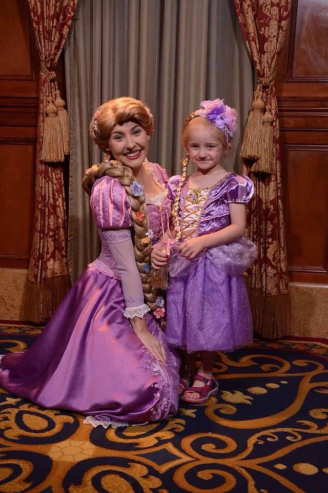 Daughter poses with Rapunzel at Walt Disney World while dressed in a Rapunzel costume.