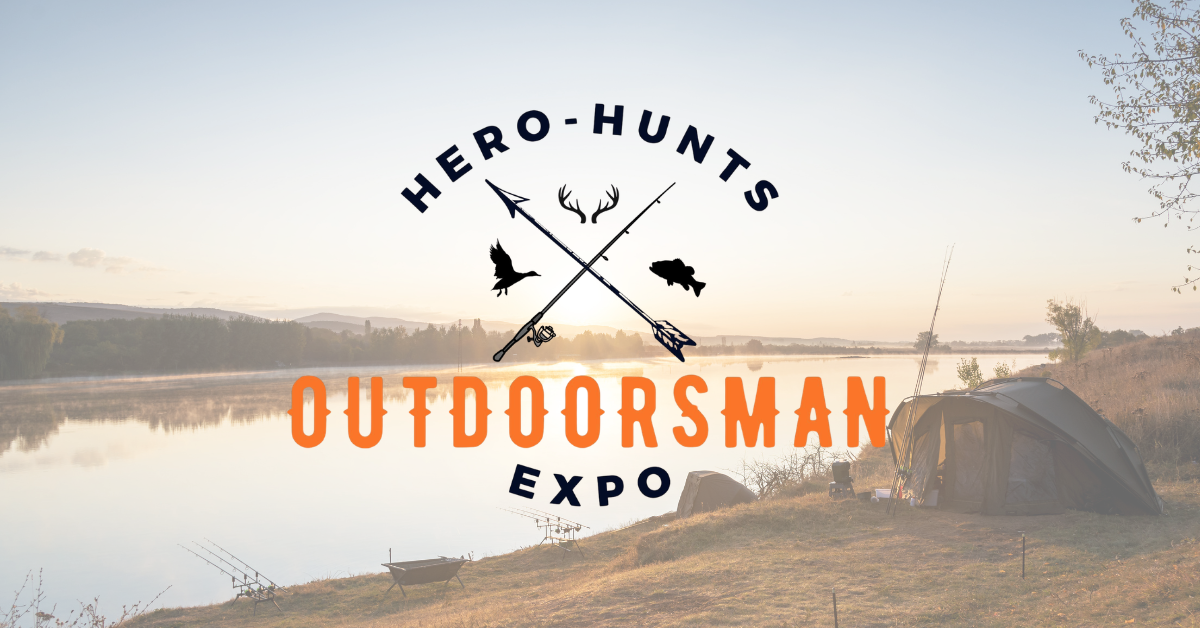 Hero-Hunts Outdoorsman Expo logo over an image of a lake at sunrise. A tent and fishing gear rest on the bank of the lake.