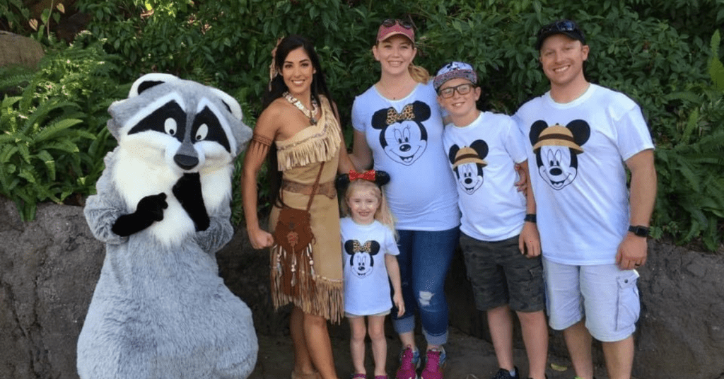 Impact veterans by sending military families on magical vacations like the one pictured here, with a family of four posing with characters at Walt Disney World